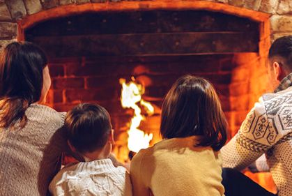 Family circled at an evening hearth